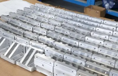 Low-volume CNC machined aluminum parts arranged in small batches for repeatable production.