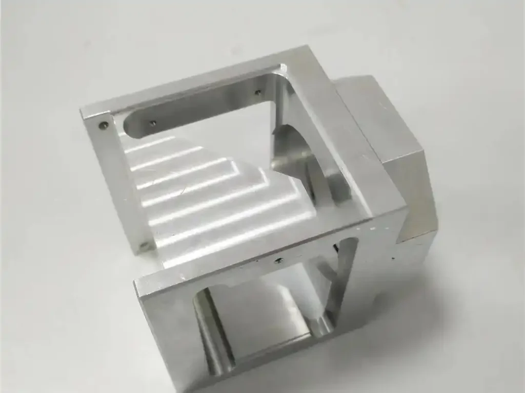 Raw aluminum raw component demonstrating complex CNC geometry required for intricate smart speaker mounts.