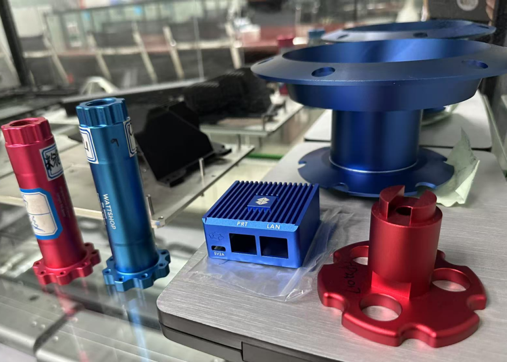 Red and blue anodized aluminum CNC machined parts showing surface-finishing options for custom components.