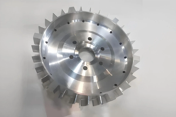 Five-axis CNC machined impeller wheel with complex angled blades and precision-machined surfaces.