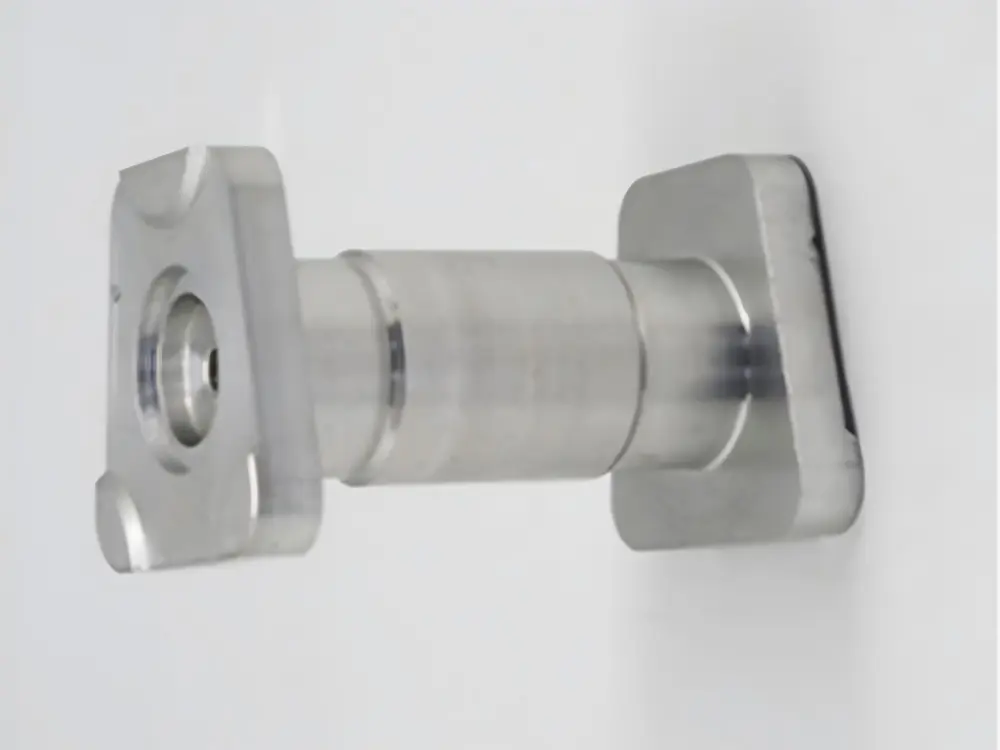 CNC turn-mill shaft with a cylindrical body and square machined flanges at both ends.